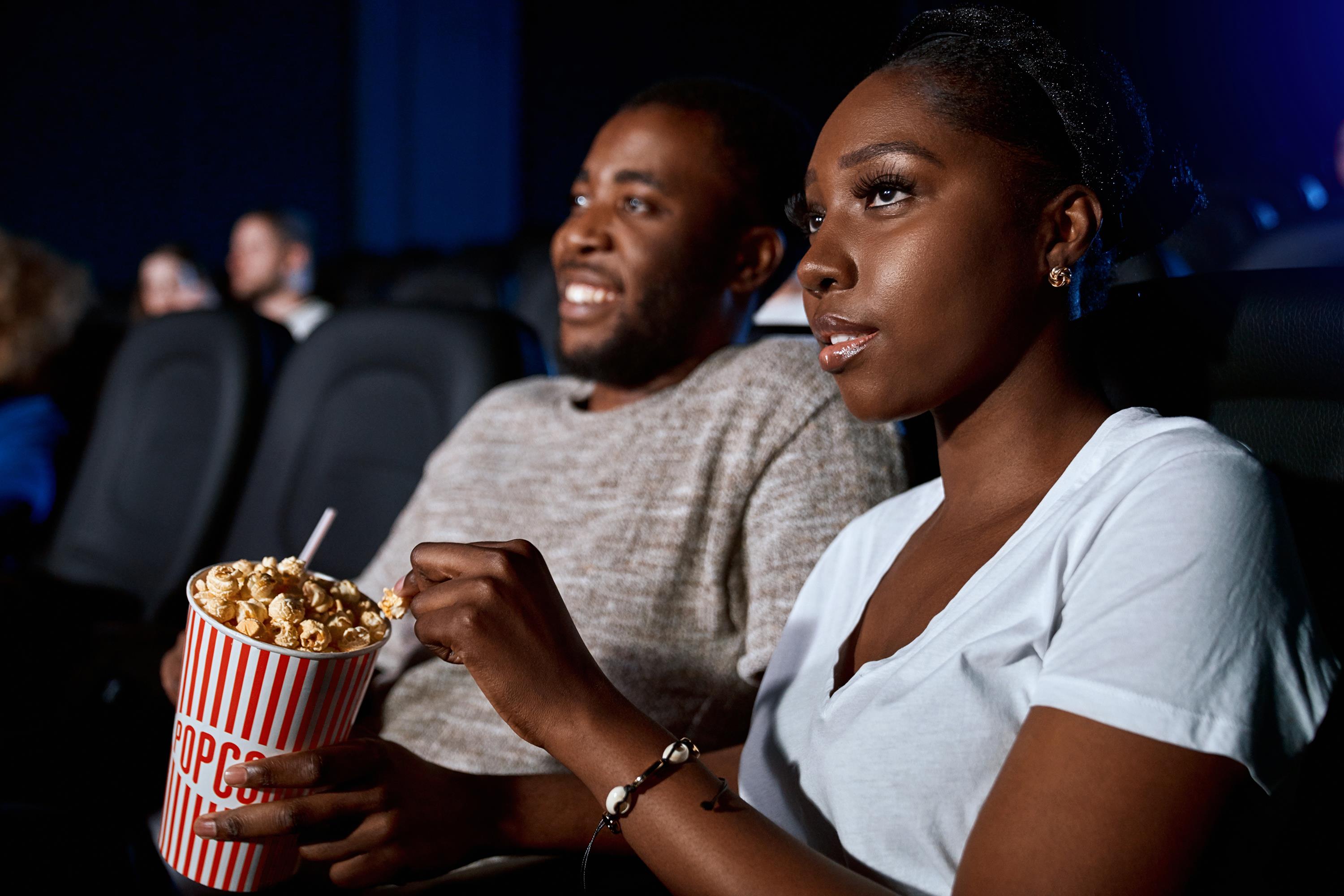 Couple watching movie with popcorn