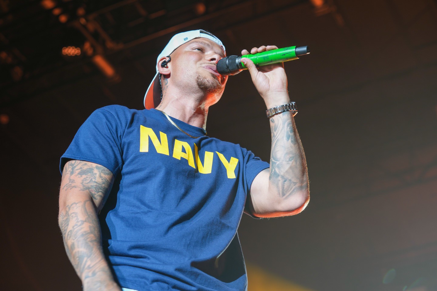 Kane Brown performing on stage during the Pensacola Operation MWR concert