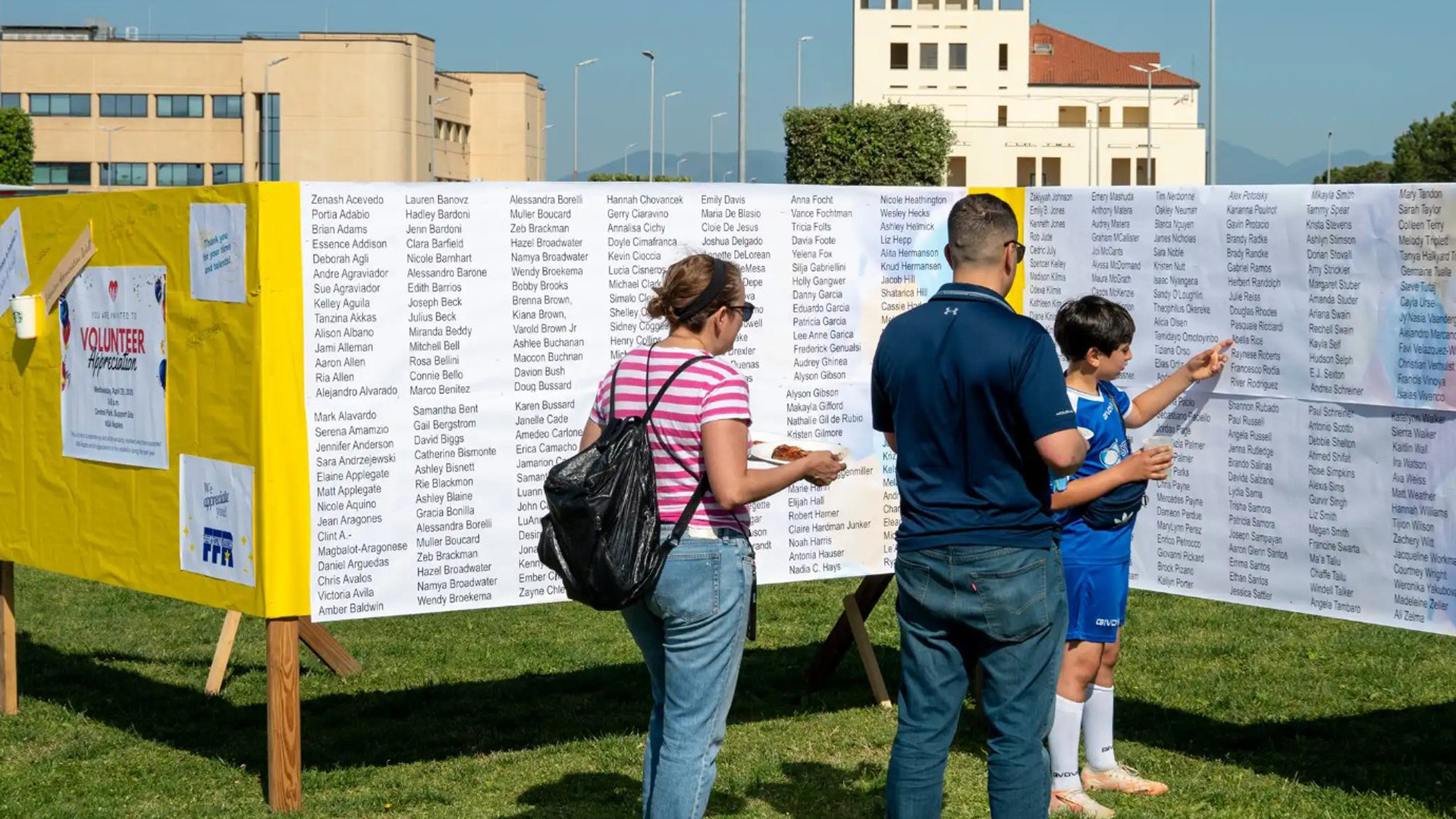 Family looking at the volunteer appreciation wall
