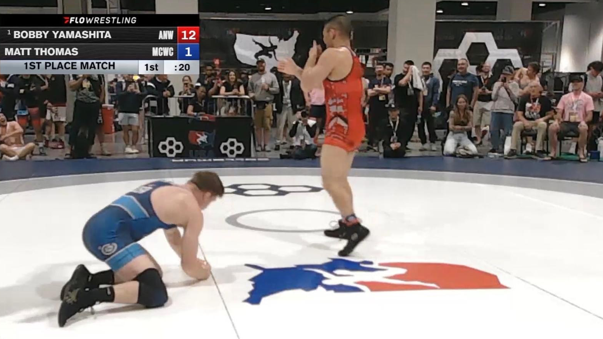 Master-at-Arms First Class (MA1) Robert Yamashita celebrating after winning a wrestling match